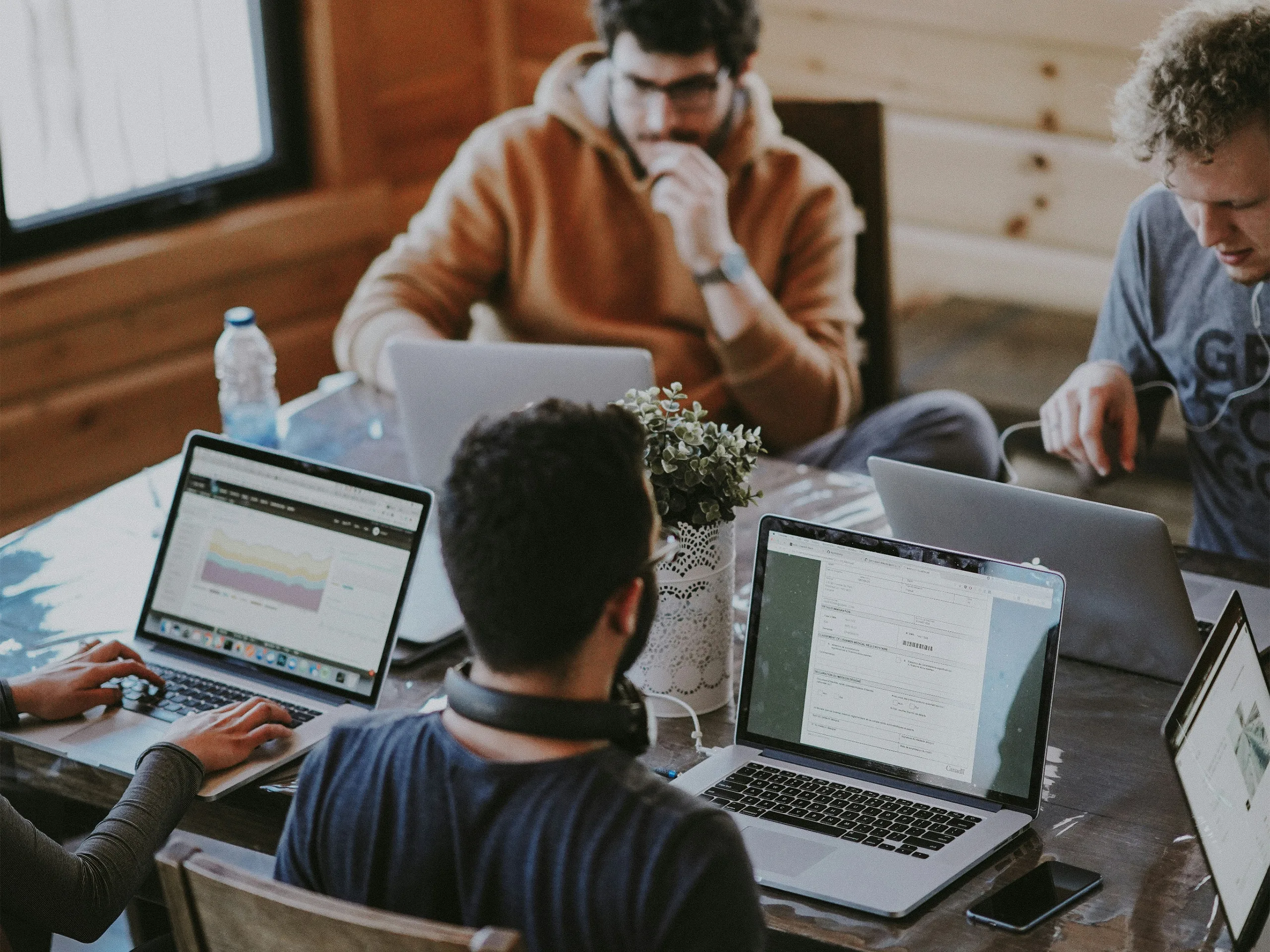 Computer users gathered at a a group of desks